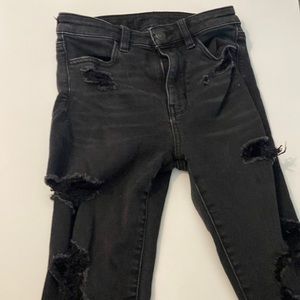 Black AE jeans with rips all the way down Size 0